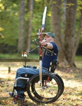Man in wheelchair shooting a bow